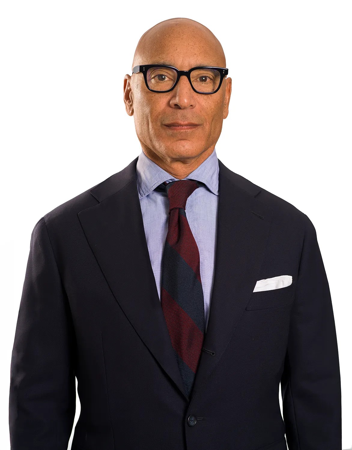 Corporate executive headshot of a man in a dark navy suit and striped tie against a pure white background — Headshots by Guffy, San Diego